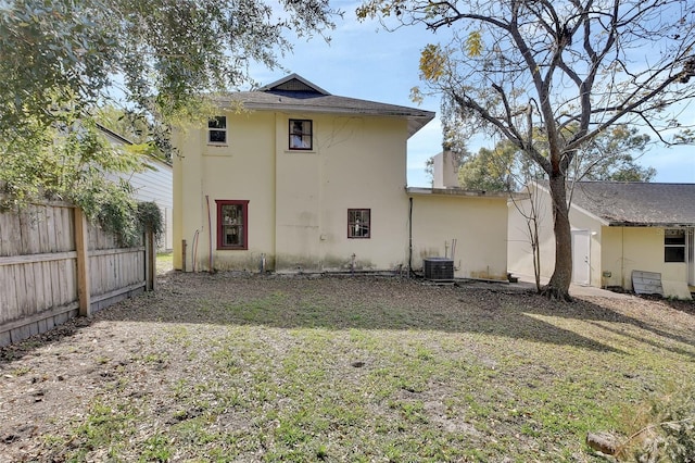 rear view of property with a lawn