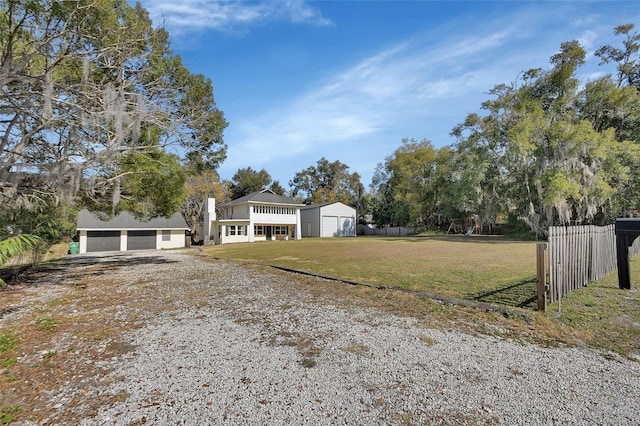 view of yard featuring a garage and an outdoor structure