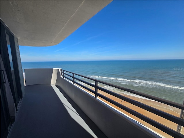 balcony with a view of the beach and a water view