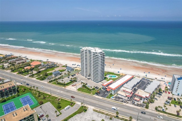 drone / aerial view with a water view and a view of the beach