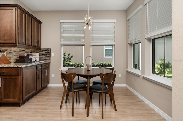 dining space with a chandelier and light hardwood / wood-style flooring