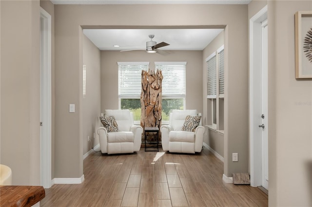 sitting room with ceiling fan and light hardwood / wood-style floors