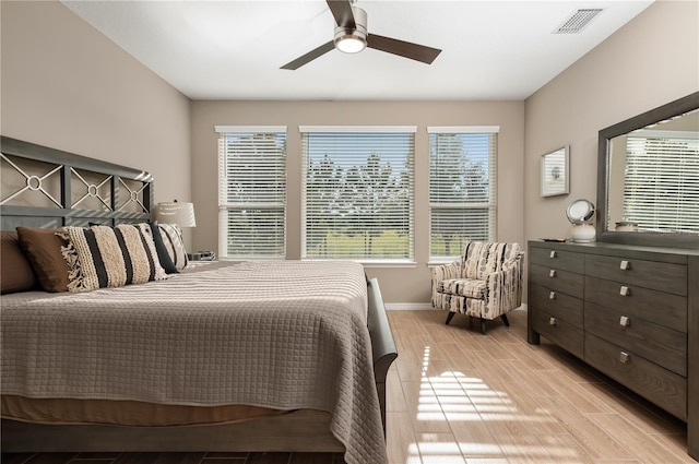 bedroom with light hardwood / wood-style flooring and ceiling fan