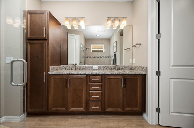 bathroom featuring vanity and a shower with shower door