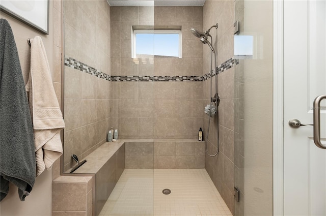 bathroom featuring a shower with door