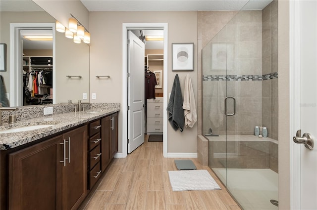 bathroom featuring vanity, wood-type flooring, and an enclosed shower