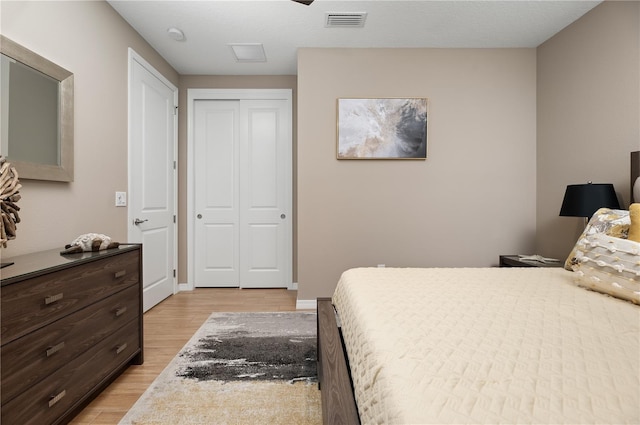 bedroom featuring light hardwood / wood-style floors and a closet