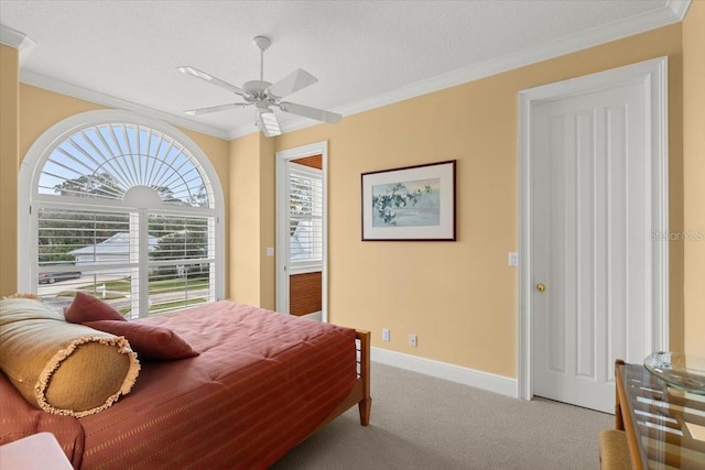 carpeted bedroom featuring crown molding and ceiling fan