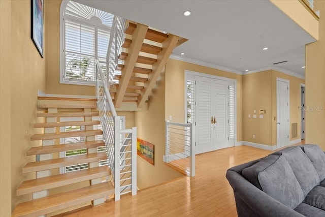 living room with hardwood / wood-style flooring and crown molding