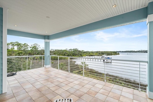 view of patio featuring a water view and a balcony