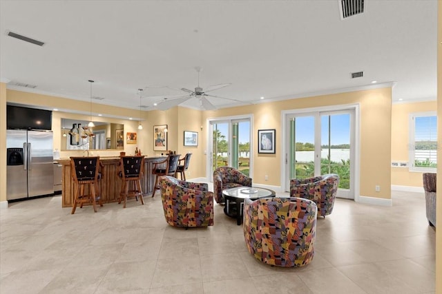 tiled living room with crown molding and ceiling fan