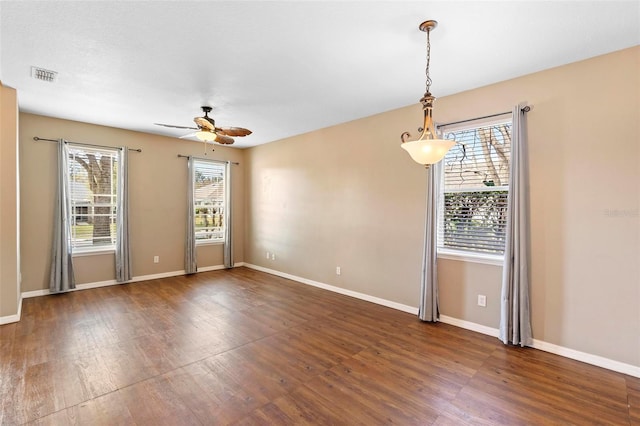 empty room with dark wood-type flooring and ceiling fan