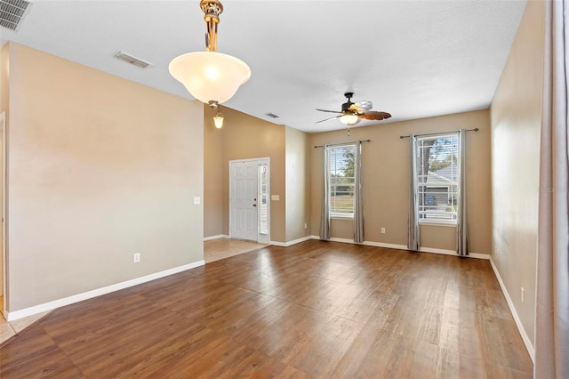 empty room featuring hardwood / wood-style flooring and ceiling fan