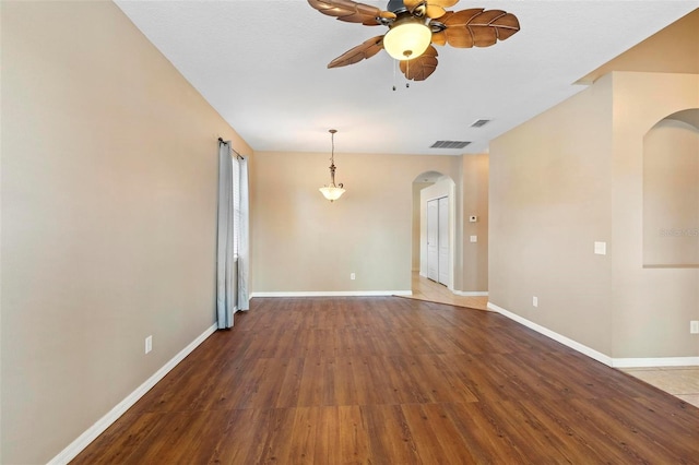 spare room with hardwood / wood-style floors and ceiling fan