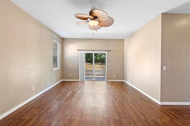 spare room featuring ceiling fan, a textured ceiling, and dark hardwood / wood-style flooring