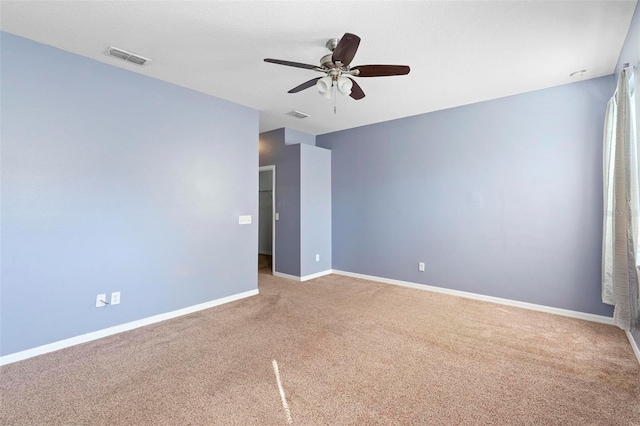 carpeted spare room with ceiling fan