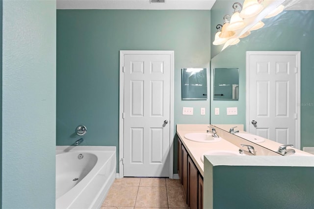 bathroom with tile patterned flooring, vanity, and a tub