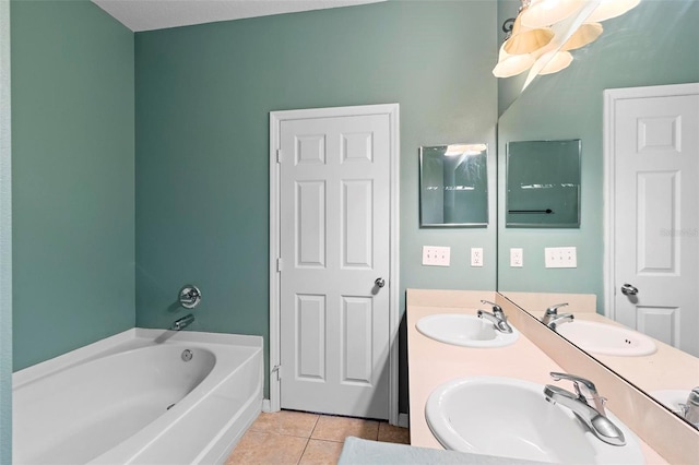 bathroom with tile patterned flooring, a tub to relax in, and vanity