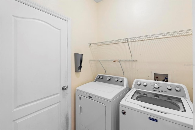 washroom featuring washing machine and dryer