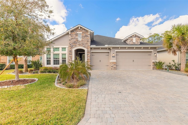 view of front facade with a garage and a front yard