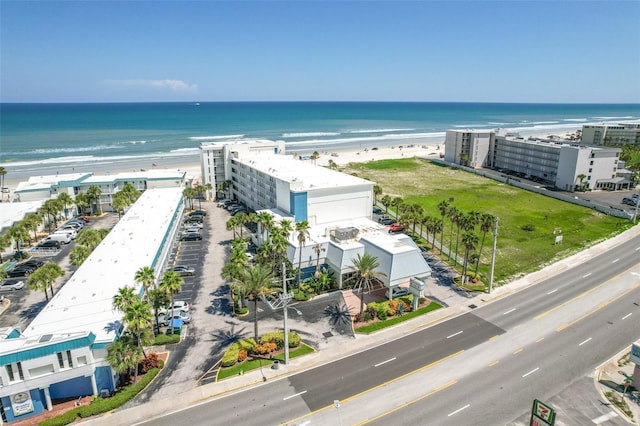 birds eye view of property featuring a beach view and a water view