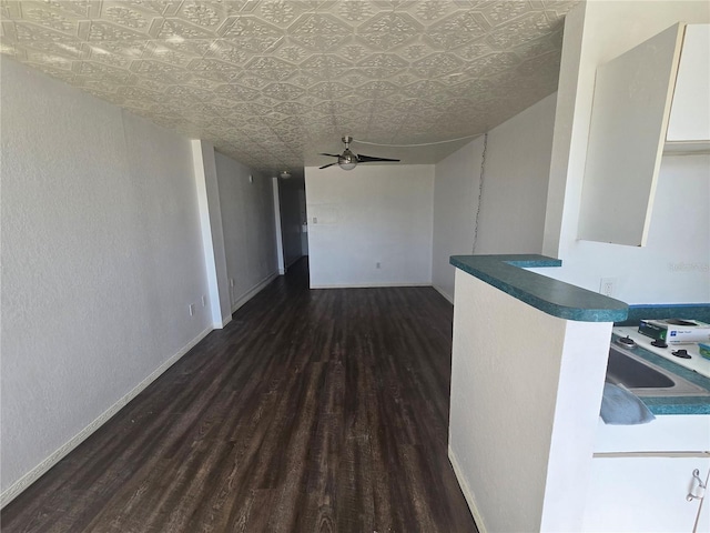 interior space featuring ceiling fan and dark hardwood / wood-style flooring