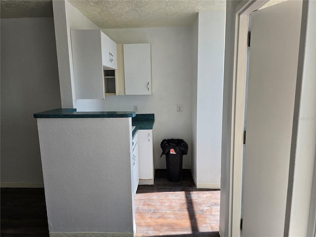 kitchen with white cabinetry and dark wood-type flooring