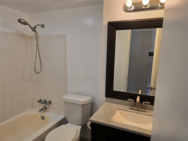 full bathroom with vanity, tiled shower / bath, and toilet