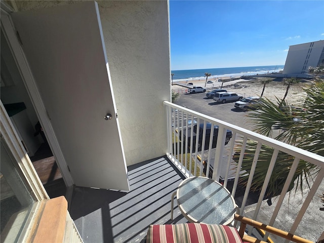 balcony with a view of the beach and a water view