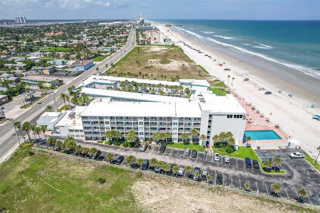 drone / aerial view featuring a water view and a view of the beach