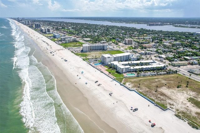 aerial view with a water view and a beach view