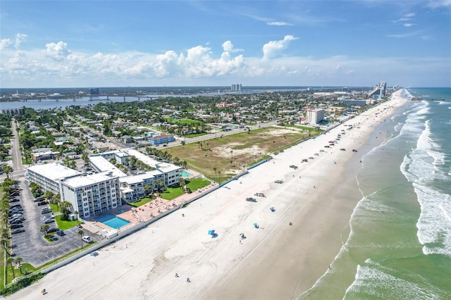 bird's eye view with a water view and a beach view