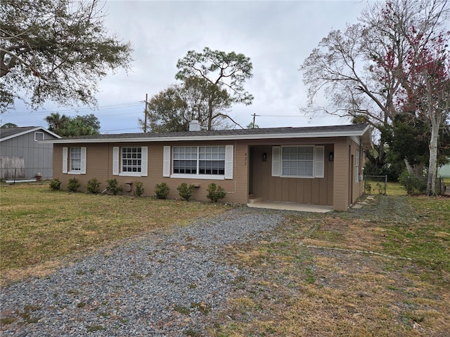 ranch-style home featuring a front yard