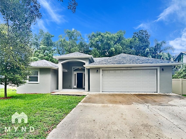 view of front of house featuring a garage and a front yard