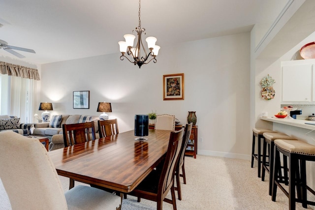 dining area with ceiling fan with notable chandelier