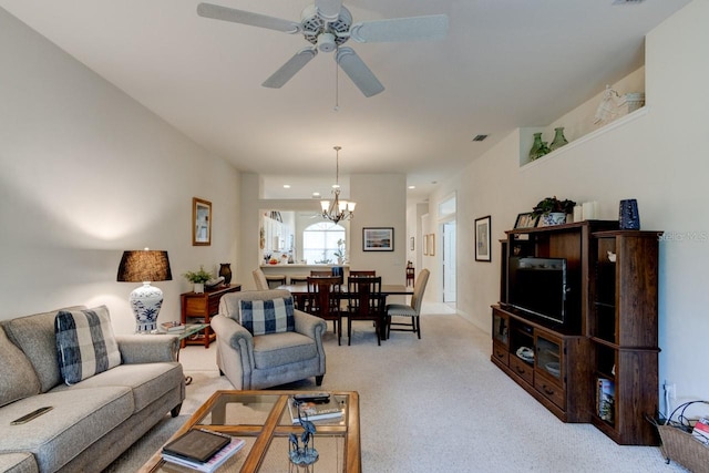 carpeted living room with ceiling fan with notable chandelier