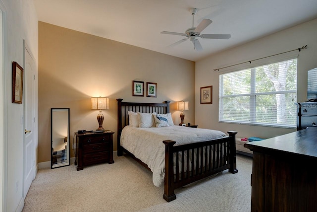 bedroom with light colored carpet and ceiling fan