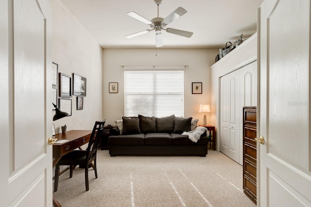 living room featuring ceiling fan and light colored carpet