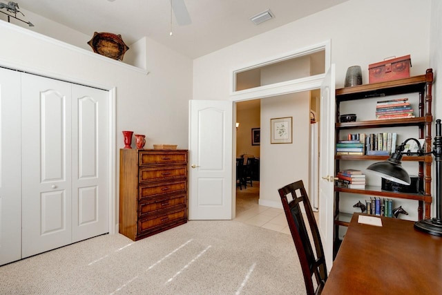 carpeted office featuring ceiling fan