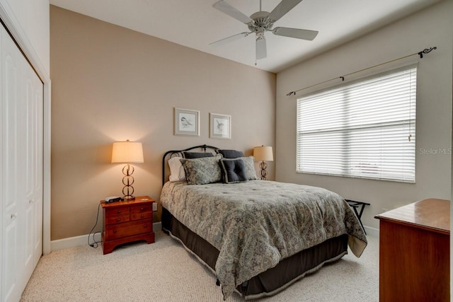 carpeted bedroom featuring ceiling fan and a closet