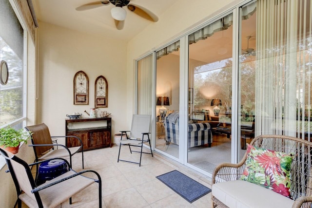 sunroom / solarium featuring ceiling fan