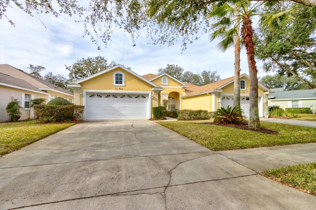 ranch-style house with a garage and a front lawn