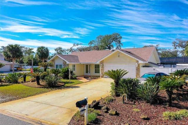 single story home with a garage and a front lawn