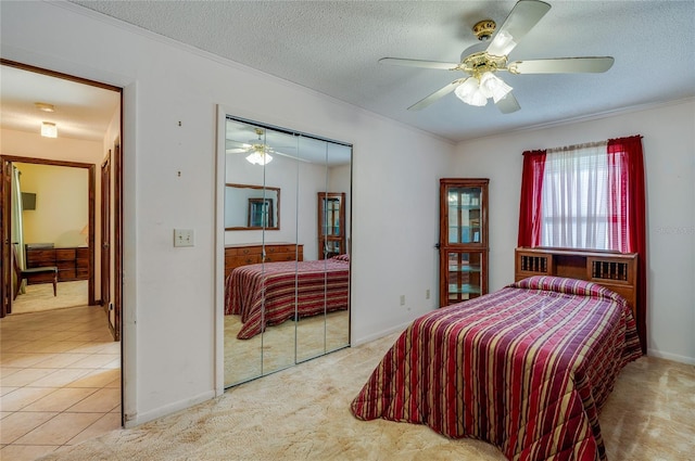 bedroom featuring crown molding, a textured ceiling, and a closet