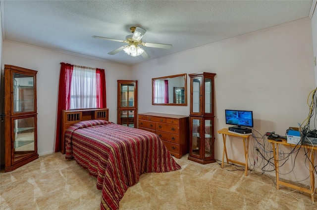 carpeted bedroom featuring ceiling fan and a textured ceiling