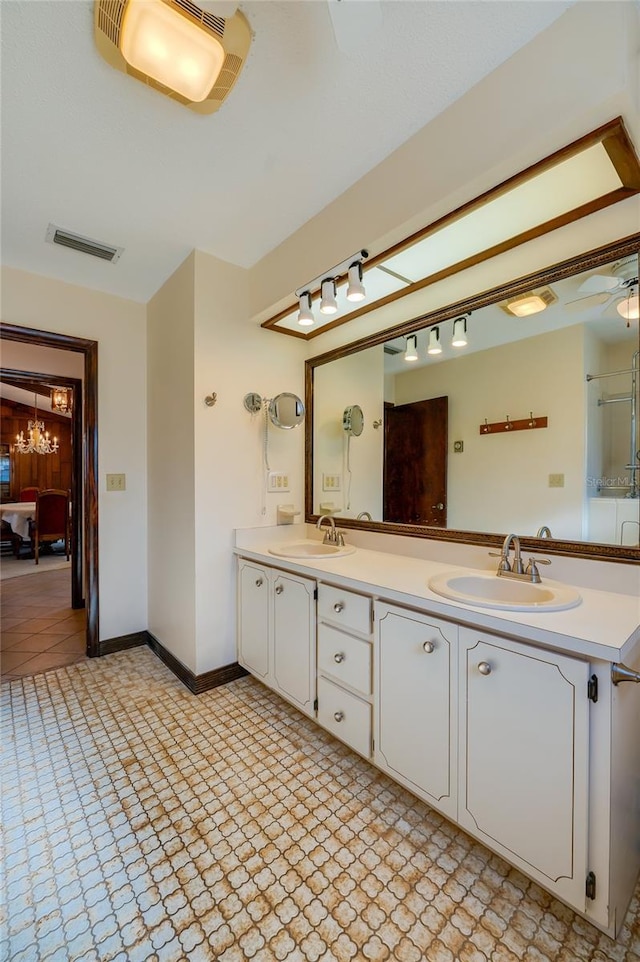 bathroom featuring vanity and a notable chandelier