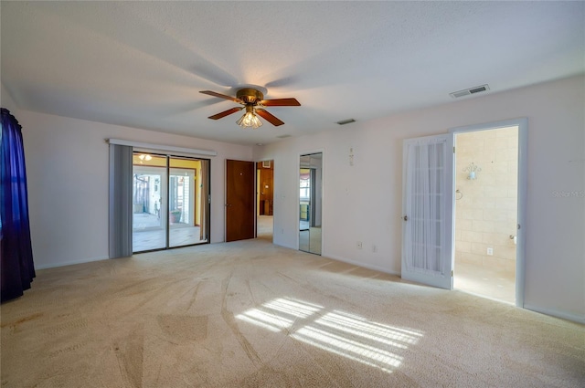 spare room featuring light carpet and ceiling fan