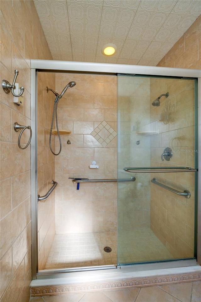 bathroom featuring a shower with shower door