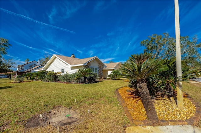 view of side of property featuring a lawn