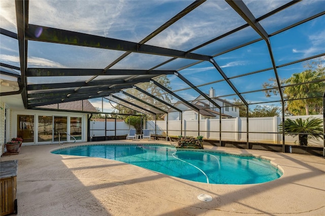 view of pool with a patio and glass enclosure